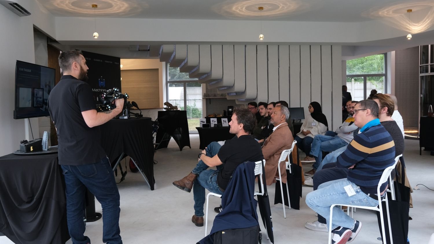 Metrology Day specialist demonstrating a 3D scanner to industry participants